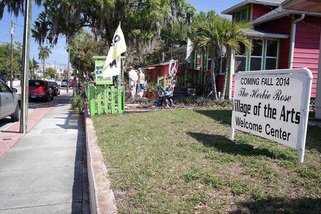 Welcome sign and painted cottages in Bradenton's Village of the Arts