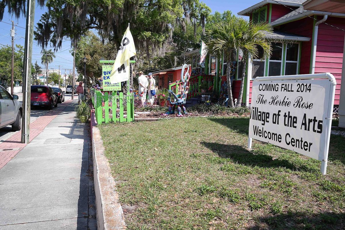 Welcome sign and painted cottages in Bradenton's Village of the Arts